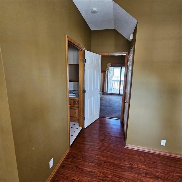2007 Windsor Dr, Pittsburg, KS 66762 - hall featuring dark wood-style flooring, vaulted ceiling, and baseboards