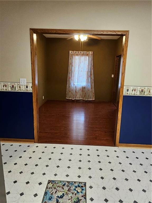 empty room featuring wood-type flooring and ceiling fan