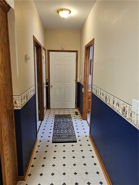 hallway with a textured ceiling