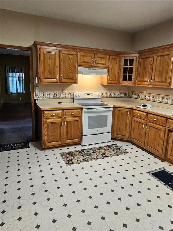 2007 Windsor Dr, Pittsburg, KS 66762 - kitchen featuring electric stove, brown cabinetry, under cabinet range hood, and light countertops