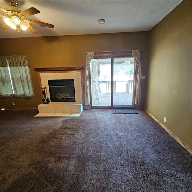 unfurnished living room with carpet, ceiling fan, and a fireplace