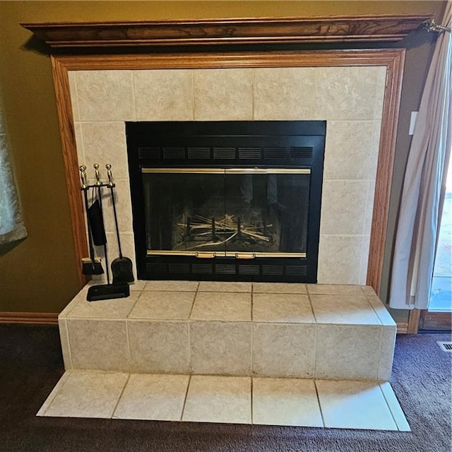 details featuring a fireplace and carpet flooring