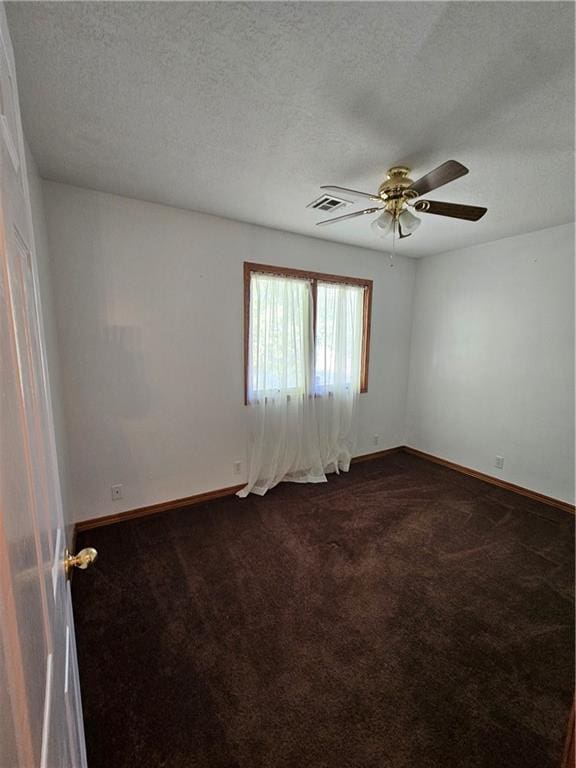 carpeted empty room with a textured ceiling and ceiling fan