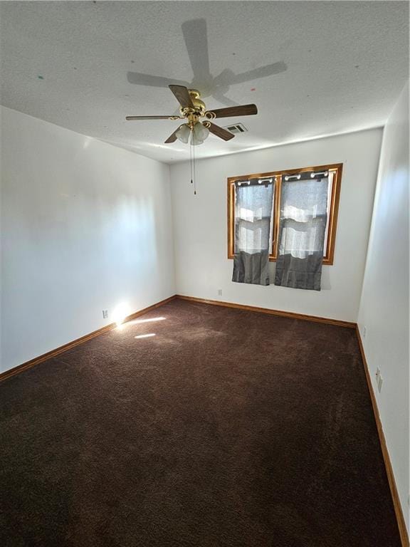 unfurnished room featuring a textured ceiling, carpet, and ceiling fan