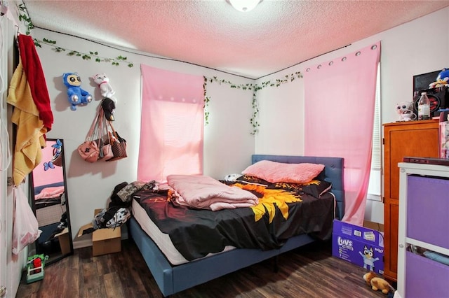 bedroom featuring a textured ceiling and dark hardwood / wood-style flooring