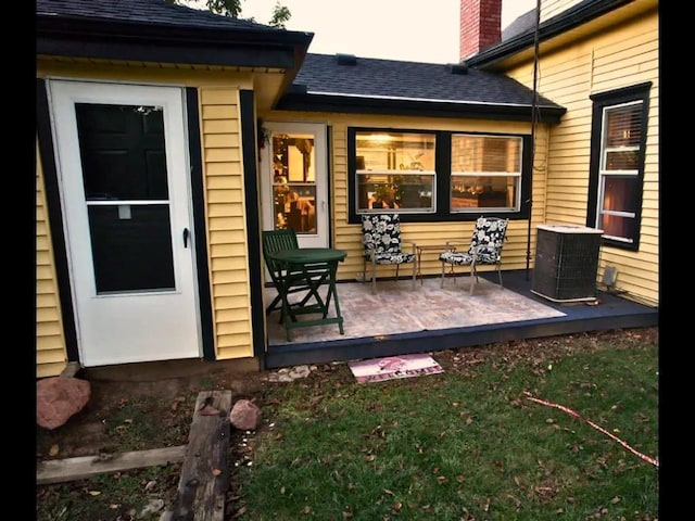 back of house with a lawn and cooling unit