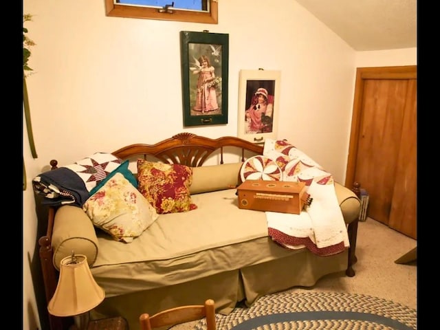 carpeted bedroom with lofted ceiling