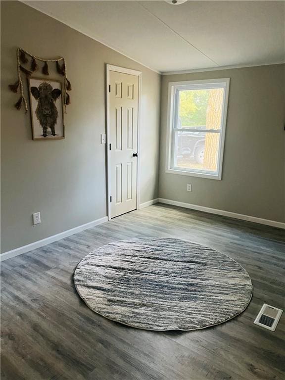 unfurnished room with wood-type flooring