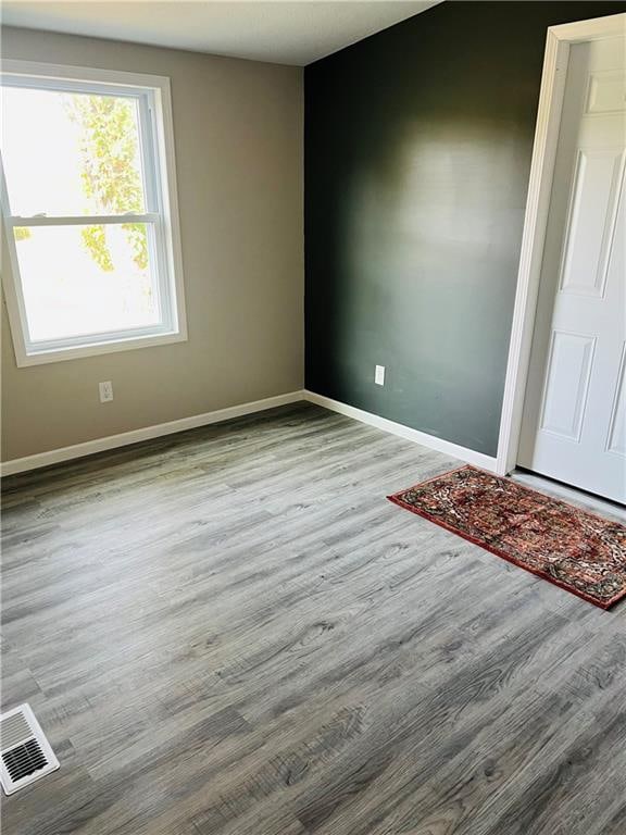 spare room featuring light wood-type flooring