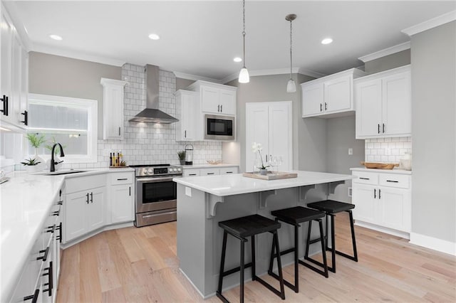 kitchen with electric stove, white cabinetry, black microwave, and wall chimney exhaust hood