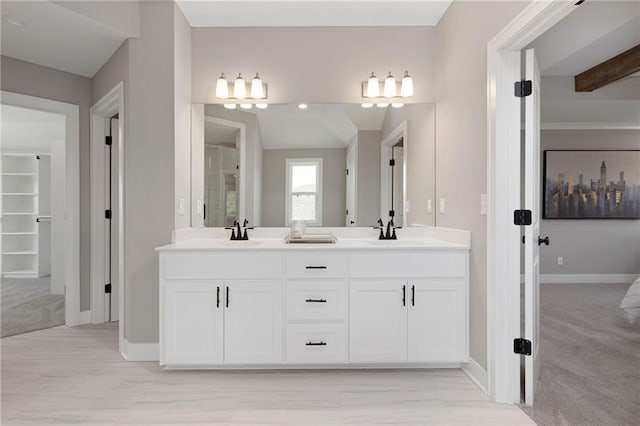 bathroom with vanity and vaulted ceiling