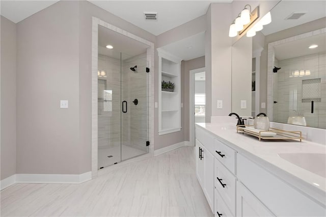 bathroom featuring an enclosed shower, vanity, and built in features