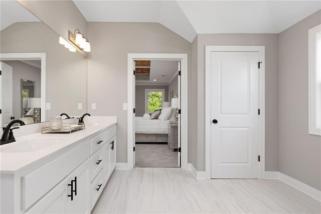 bathroom with vanity and vaulted ceiling