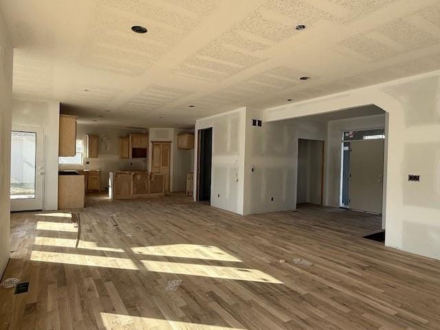 unfurnished living room featuring wood-type flooring