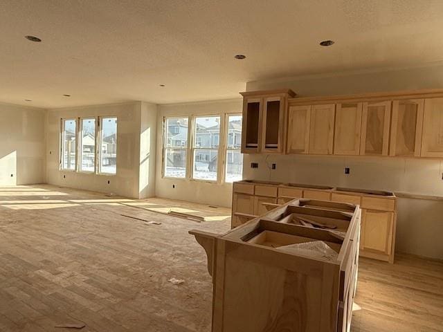 kitchen featuring a wealth of natural light, a center island, and light brown cabinets