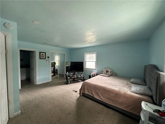 bedroom with carpet floors and a textured ceiling