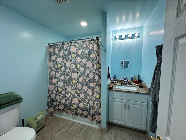 full bathroom featuring vanity, tile patterned flooring, toilet, and shower / tub combo