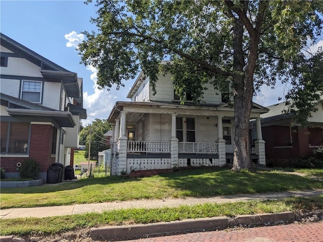 view of front of house featuring a front lawn and covered porch