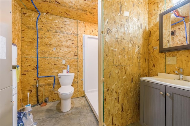 bathroom featuring vanity, toilet, and concrete floors