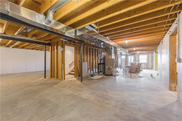 basement featuring water heater and heating unit