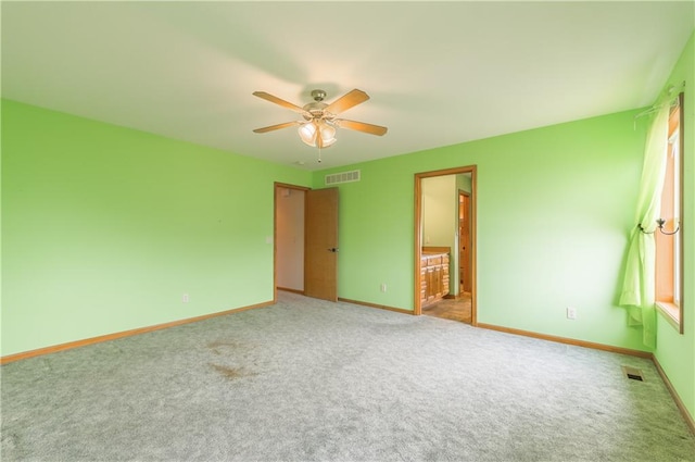 spare room with ceiling fan and carpet floors