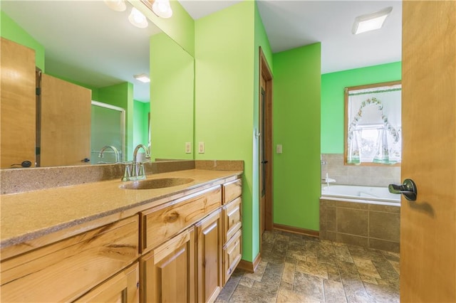 bathroom with a relaxing tiled tub and vanity