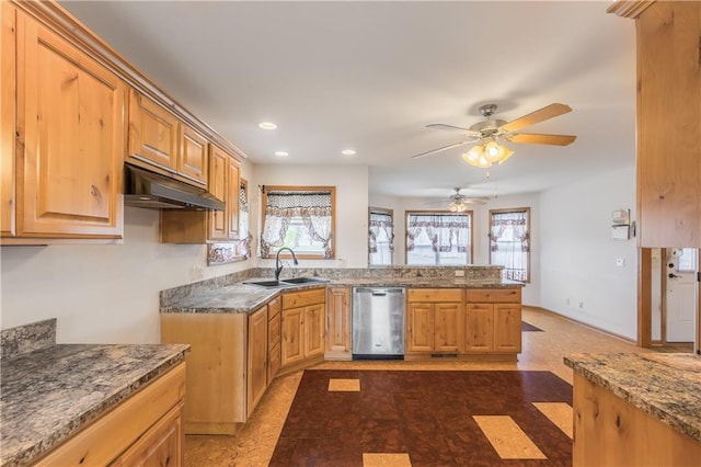 kitchen featuring carpet floors, dark stone counters, sink, stainless steel dishwasher, and ceiling fan