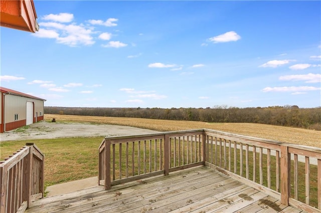 wooden terrace with a rural view and a yard