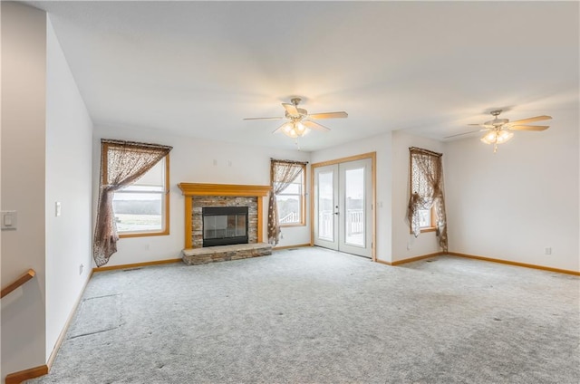 unfurnished living room featuring ceiling fan, french doors, and light colored carpet