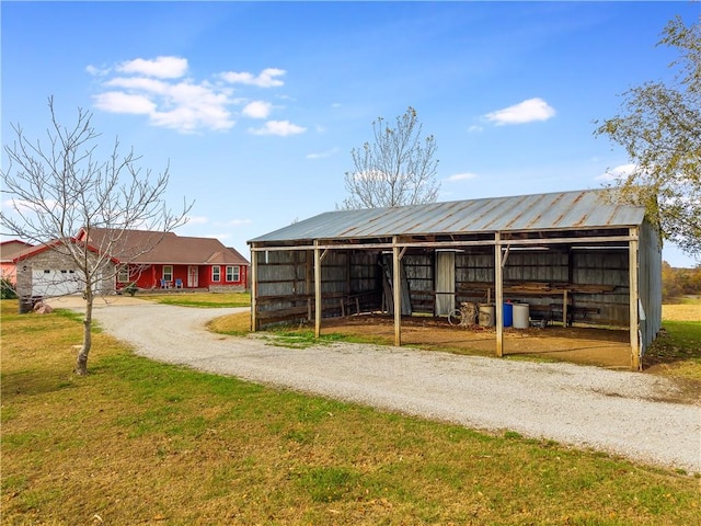 view of property's community with a yard and an outdoor structure