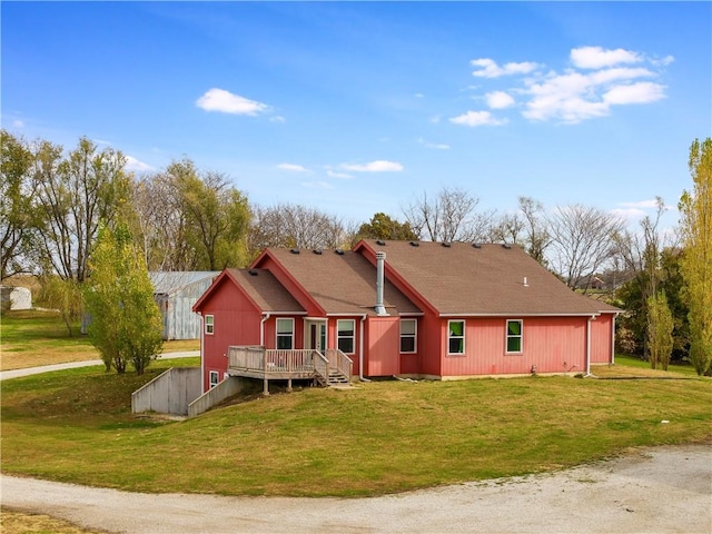 back of property with a yard and a deck