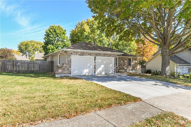 view of front of property featuring a front lawn and a garage