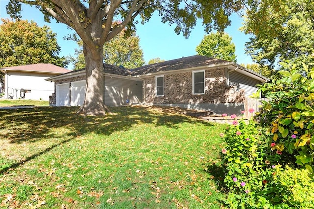 single story home featuring a front yard and a garage