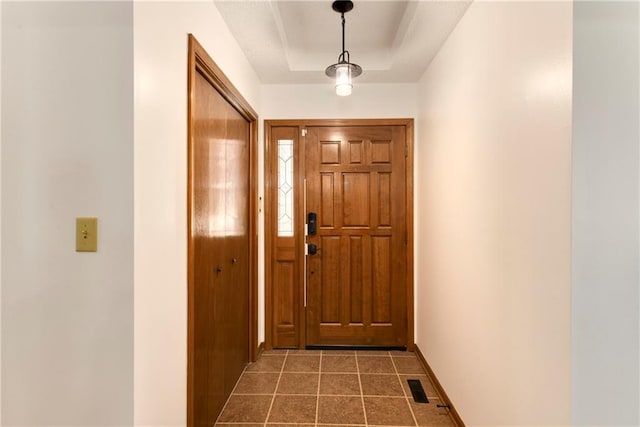 entryway with a raised ceiling