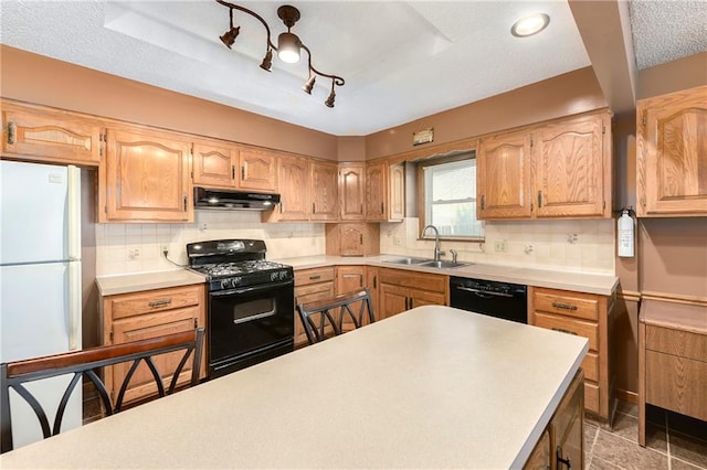 kitchen with decorative backsplash, black appliances, sink, and a textured ceiling