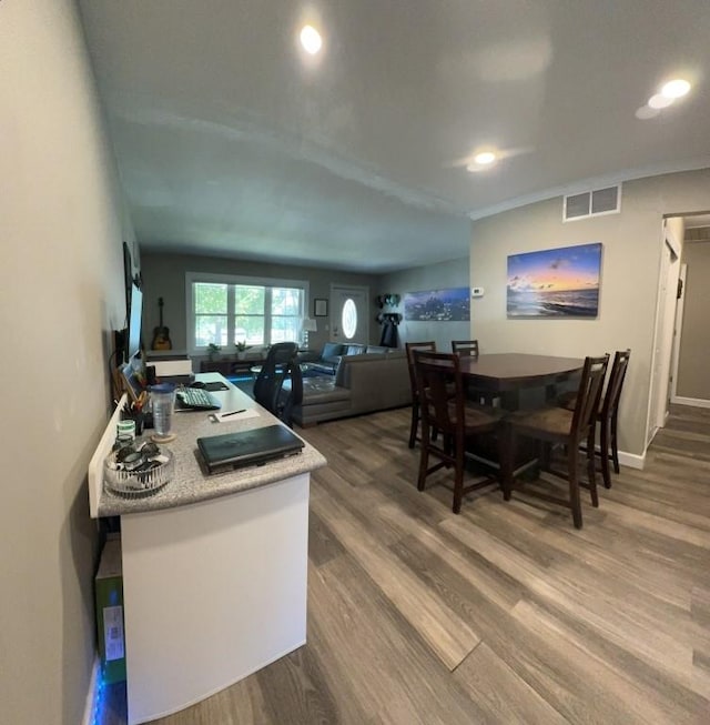 dining space with hardwood / wood-style floors