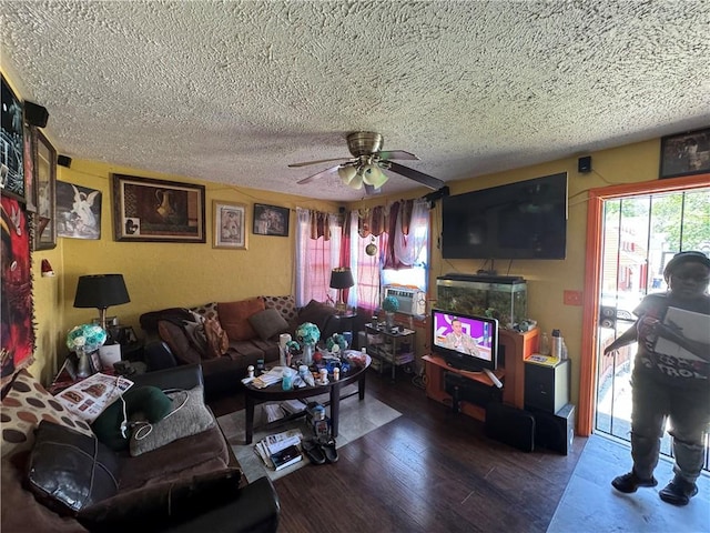 living room with a textured ceiling, ceiling fan, and hardwood / wood-style flooring