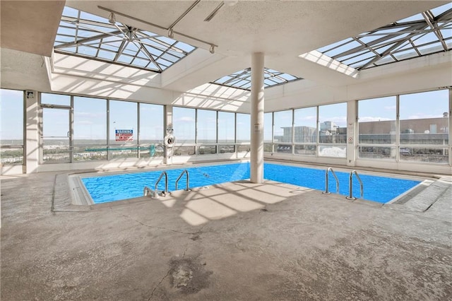 view of pool with a patio and a lanai