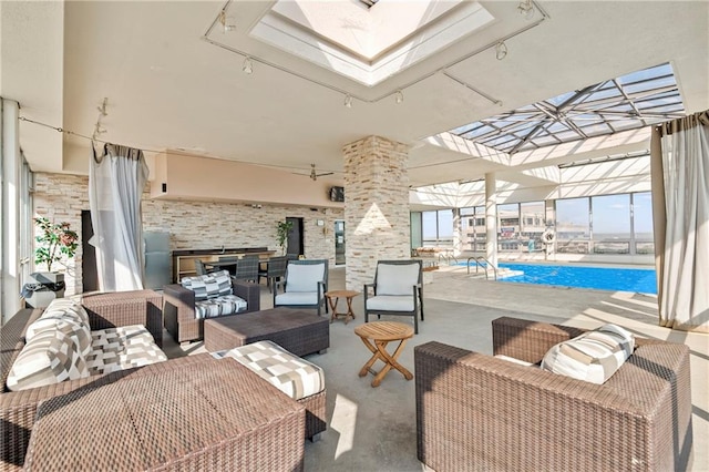 view of patio / terrace featuring an outdoor hangout area, glass enclosure, and an indoor pool