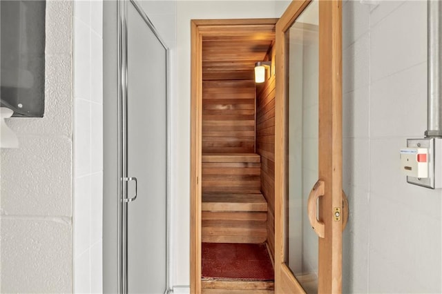 view of sauna / steam room featuring wood walls