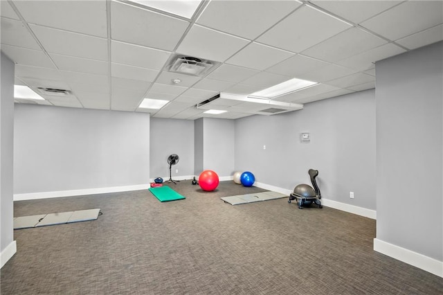 exercise room featuring a paneled ceiling and carpet flooring