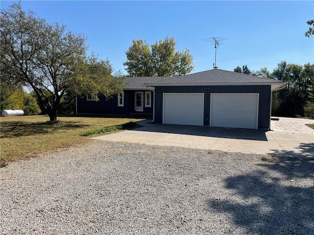 single story home featuring a front lawn and a garage