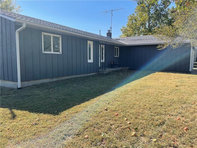 rear view of property with a yard