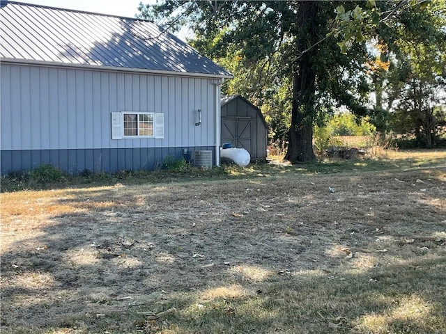 view of home's exterior featuring a storage unit and central AC