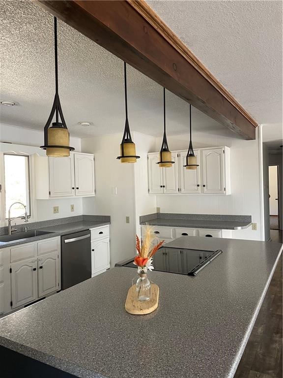 kitchen featuring beamed ceiling, sink, stainless steel dishwasher, a textured ceiling, and white cabinetry