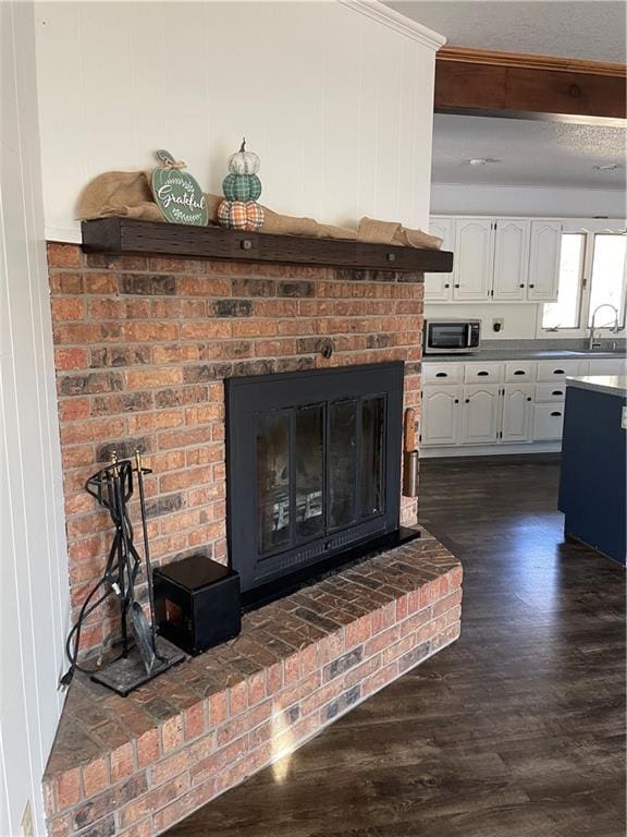 details with wood-type flooring, a fireplace, and sink