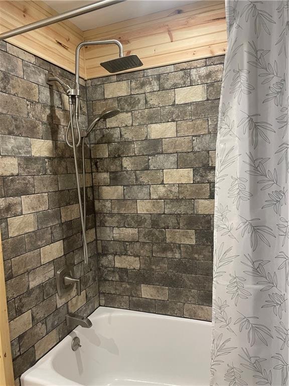 bathroom with shower / bath combo with shower curtain