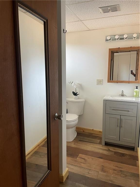 bathroom featuring vanity, toilet, and hardwood / wood-style flooring