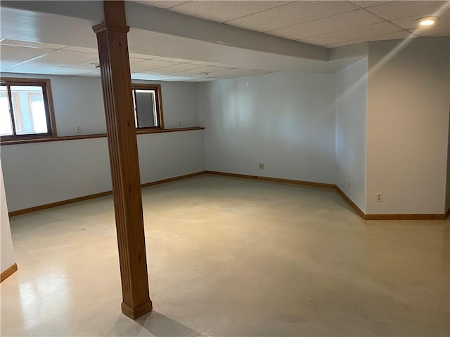 basement with a paneled ceiling