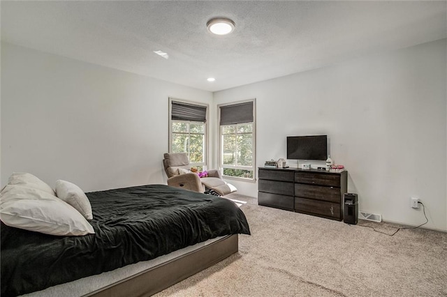 carpeted bedroom featuring a textured ceiling